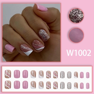 Pink and silver glitter press-on nail kit with wavy lines and solid color designs