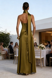 Detailed back view of olive green satin evening dress featuring lace-up back design