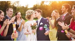 Wedding confetti poppers releasing colorful paper scraps during an outdoor ceremony