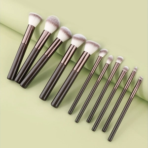 Detail view of 11 professional makeup brushes with rose gold ferrules and wooden handles
