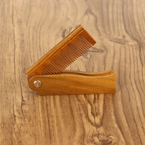 Handcrafted folding green sandalwood beard comb with natural wood grain and metal screw pivot