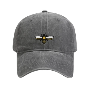 Close-up detail of bumblebee embroidery on washed dark grey cotton baseball cap