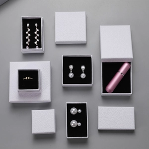Overhead view of white textured jewelry gift boxes with elegant lychee pattern detail