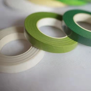 Macro shot of multi-colored floral crepe paper rolls in light green and cream white tones