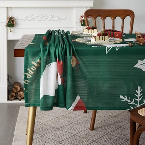 Festive green Christmas table runner with Santa motifs and golden Happy text decor