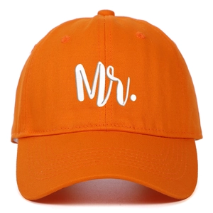 Detailed view of orange cotton baseball cap featuring 3D white Mr. embroidery