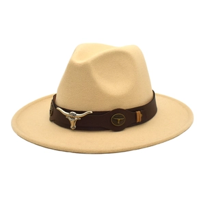 Detailed close-up of beige wool fedora hat featuring a vintage bull head metal ornament