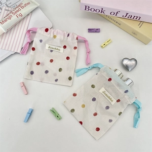 Set of two white drawstring cotton pouches with colorful polka dots for small item storage