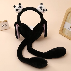 Detail of plush panda earmuffs featuring movable rabbit ears and soft faux fur texture
