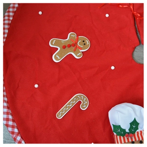Close-up of red gingerbread man Christmas tree skirt with candy cane and plaid trim