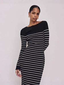 Elegant long sleeve black knit dress with white stripes and slim fit silhouette