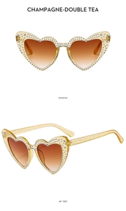 Detail view of champagne heart-shaped sunglasses with rhinestones and tea gradient lenses
