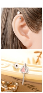 Macro detail of silver cat ear cartilage stud with pink flame tip and screw back closure