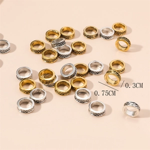 Detail of 0.75cm gold and silver alloy dreadlock rings with embossed texture patterns