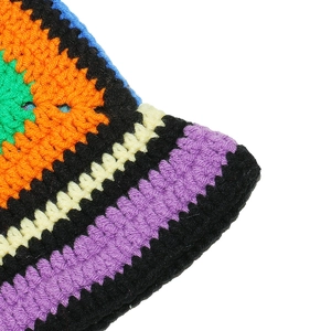 Close-up of bohemian crochet knit bucket hat with colorful floral patterns and textures