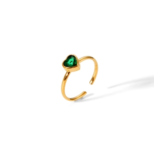 Macro shot of 18k gold plated stainless steel ring with green heart-shaped gemstone