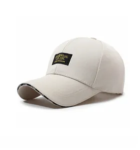 Detail of beige cotton baseball cap featuring embroidered label and FEWK lettered brim edge