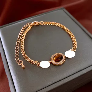 Macro detail of gold-plated tiger eye bracelet with cubic zirconia on a luxury jewelry box