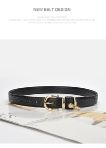 Detail of black crocodile texture leather belt with golden buckle and mini padlock charm