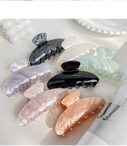 Detailed set of seven large acetate hair claws in assorted pearlescent marble finishes