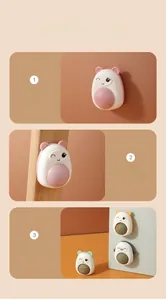 Rotating catnip wall ball toy shown mounted on walls and glass surfaces