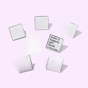 Detailed view of square metal pins with inspirational quotes on a purple background