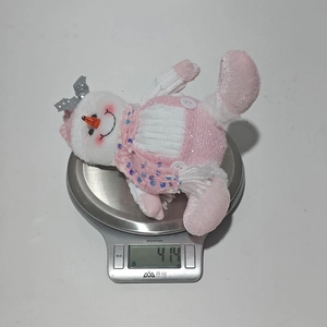 Pink sequined snowman doll weighing 41.4g on a digital scale for Christmas decor