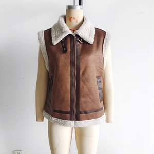 Detail of women's brown faux suede vest with shearling collar and metal zipper