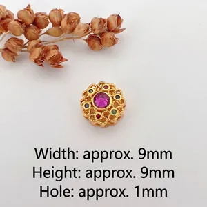 Macro shot of 9mm vintage gold floral spacer bead with colorful inset gemstones