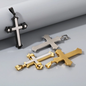 Detailed view of titanium steel cross pendants in black, gold, and silver finishes