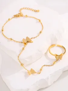 Macro detail of gold butterfly slave bracelet with frosted finish and adjustable ring