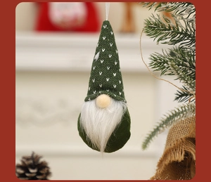 Close-up of a green knitted Christmas gnome ornament with white beard and hanging rope