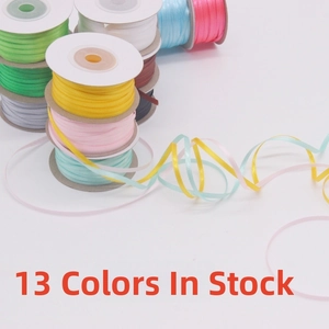 Close-up of 13 colorful 3mm double-sided satin ribbon rolls for DIY gift wrapping