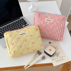 Quilted gingham cosmetic bags with bows and zippers for travel storage and makeup