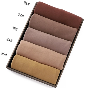 Detail view of cotton jersey hijabs in a gradient of five earthy tones with fine knit texture