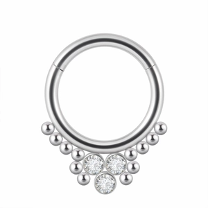 Detail of silver hinged nose ring with three clear crystals and metallic bead accents