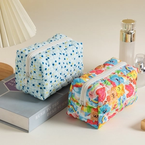 Quilted cotton makeup bags with floral and polka dot patterns in a lifestyle setting