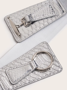 Silver metallic ring buckle on white elastic waist belt with crocodile pattern leather