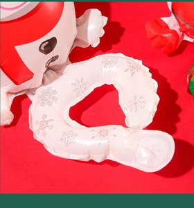 Detail of red Christmas inflatable balloon with silver snowflake patterns and seam texture
