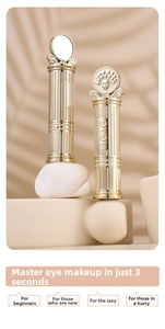 Close-up of golden AGAG double-ended eyeshadow sticks with vintage Peking opera relief detail