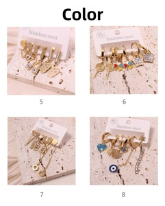 Detail of four gold-plated stainless steel earring sets with heart and clover designs