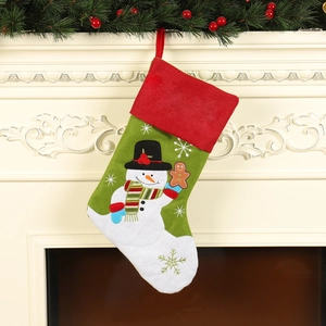 Linen Christmas stocking with snowman and gingerbread man embroidery on a festive mantel
