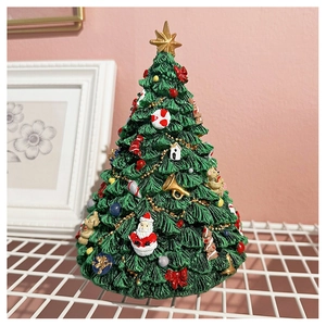 Close-up of a festive Christmas tree music box with detailed Santa and star ornaments