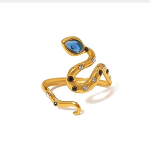 Macro view of gold snake ring featuring a teardrop blue zircon and sparkling crystal stones