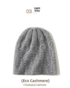 Detailed texture of light grey ecological cashmere knit hat with cable-knit pattern