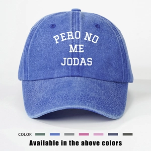 Close-up of washed denim baseball cap with PERO NO ME JODAS text and color options