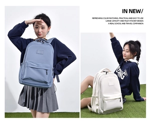 Blue and white nylon student backpacks with large capacity and multi-pocket design shown by models