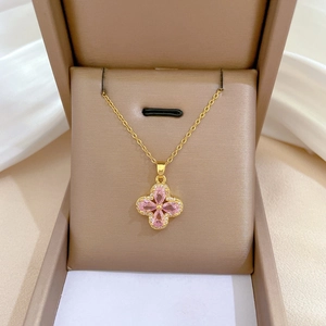 Golden titanium steel jewelry set featuring pink four-leaf flower pendant and earrings