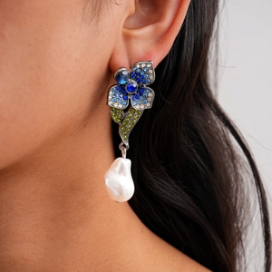 Detail of vintage flower earring with colorful crystals and white baroque pearl