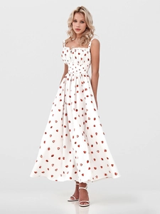 Detail of square neckline with ruching on a white summer dress featuring strawberry prints